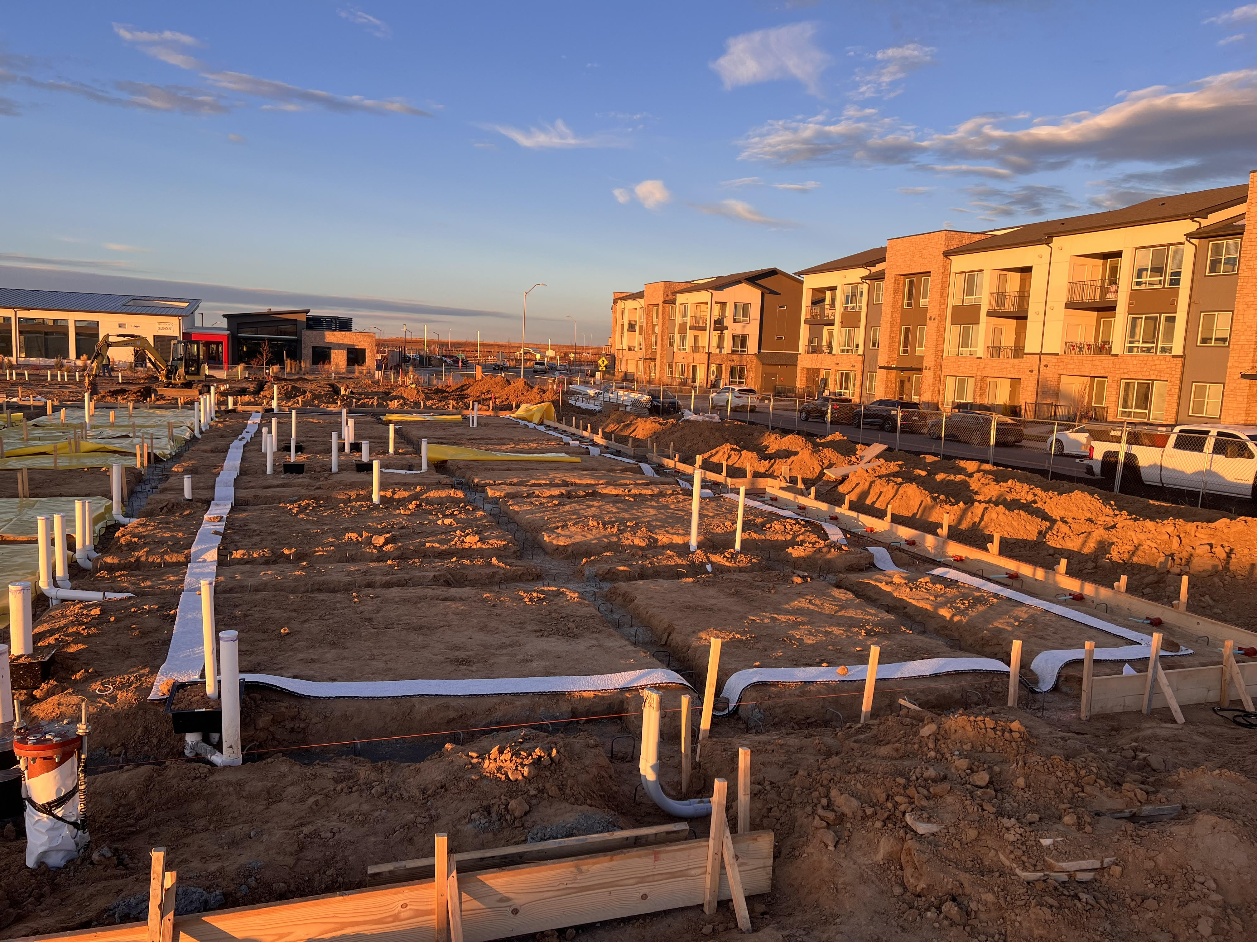 Radon rough-in piping across foundation footings at a multifamily development in the Denver metro