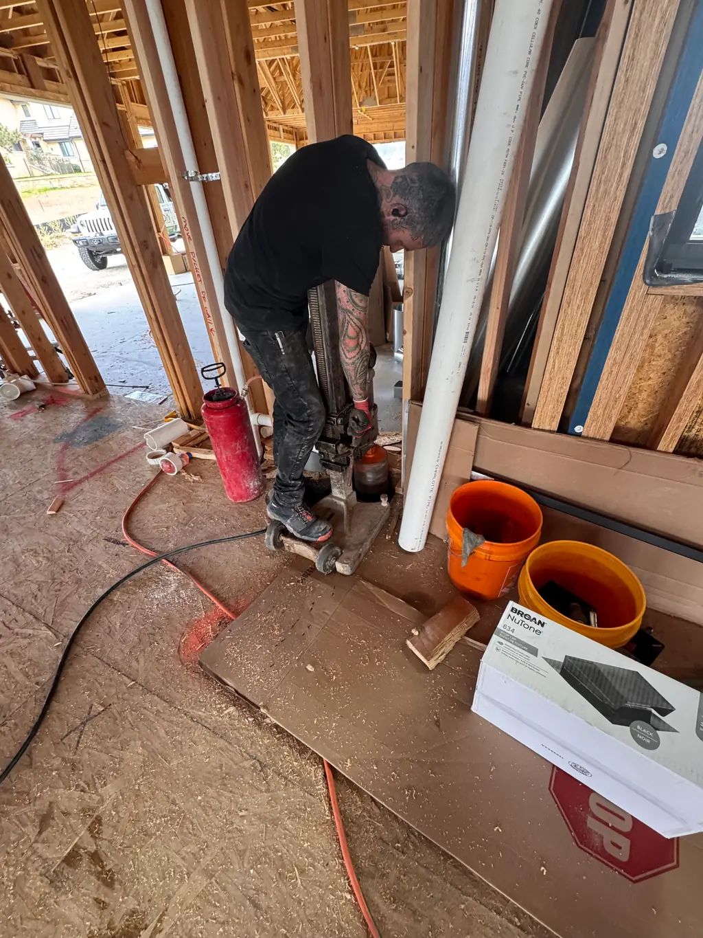 Custom Radon technician core-drilling a slab to install a radon system